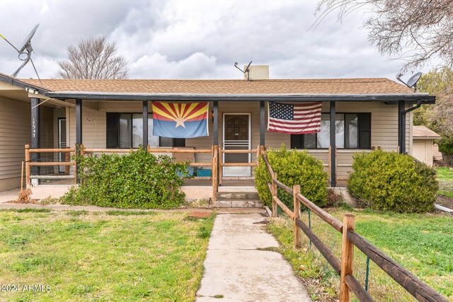 ranch-style home with a front yard and a porch