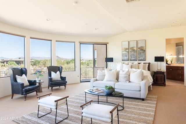 carpeted living room with lofted ceiling