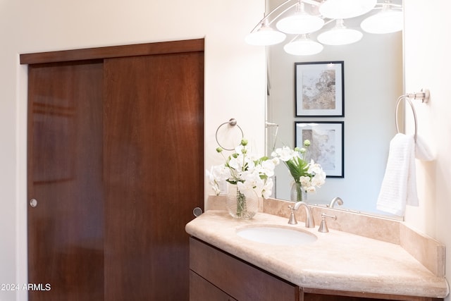 bathroom featuring an inviting chandelier and vanity