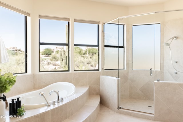 bathroom featuring independent shower and bath