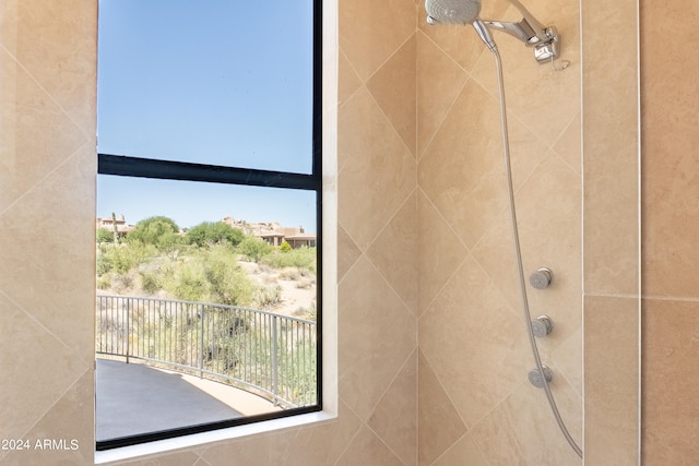 interior details featuring a tile shower