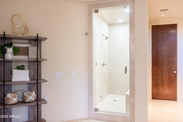 bathroom featuring a shower with door