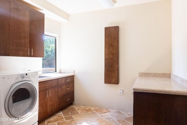 laundry area with washer / clothes dryer and cabinets