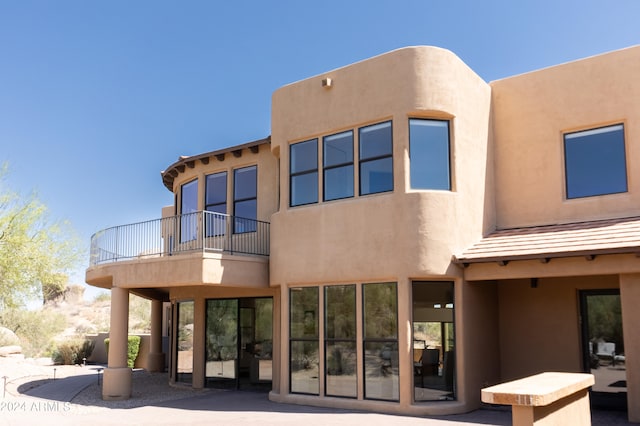 rear view of property featuring a balcony