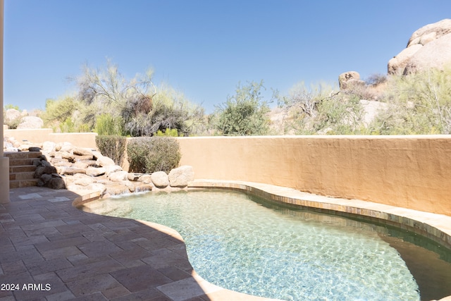 view of pool featuring a patio and pool water feature