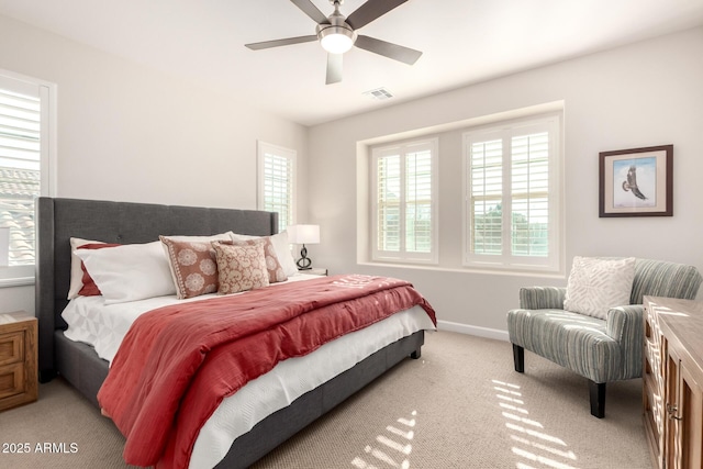 bedroom featuring a ceiling fan, light colored carpet, visible vents, and baseboards