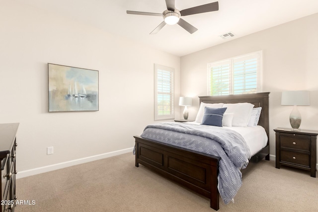 bedroom with visible vents, light colored carpet, a ceiling fan, and baseboards