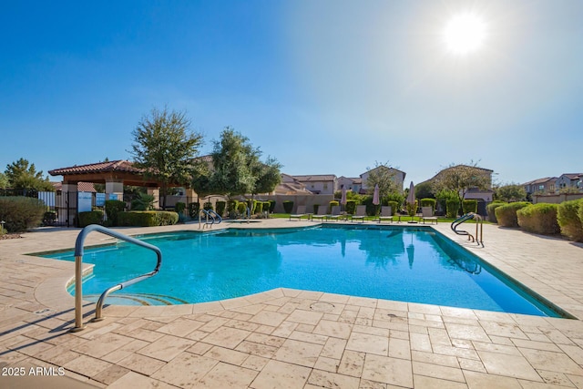 view of swimming pool featuring a fenced in pool, fence, and a patio area