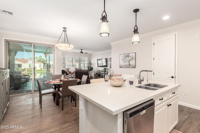 kitchen featuring wood finished floors, visible vents, ornamental molding, a sink, and stainless steel dishwasher