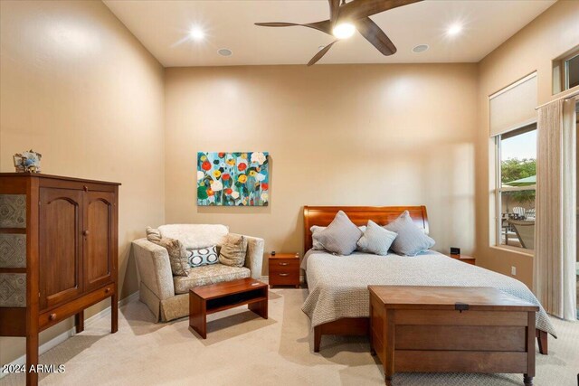 bedroom with light carpet and ceiling fan