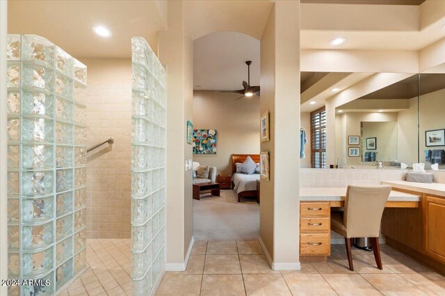 bathroom featuring tiled shower, vanity, ceiling fan, and tile patterned floors