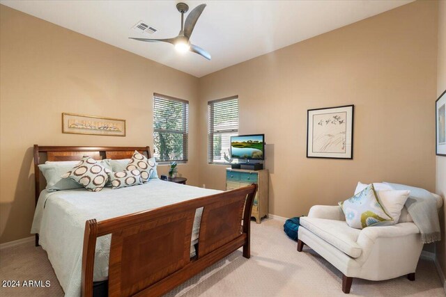 bedroom with ceiling fan and light colored carpet