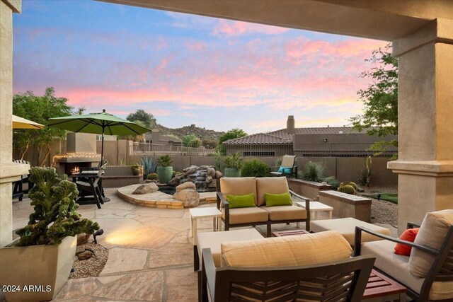 patio terrace at dusk featuring outdoor lounge area