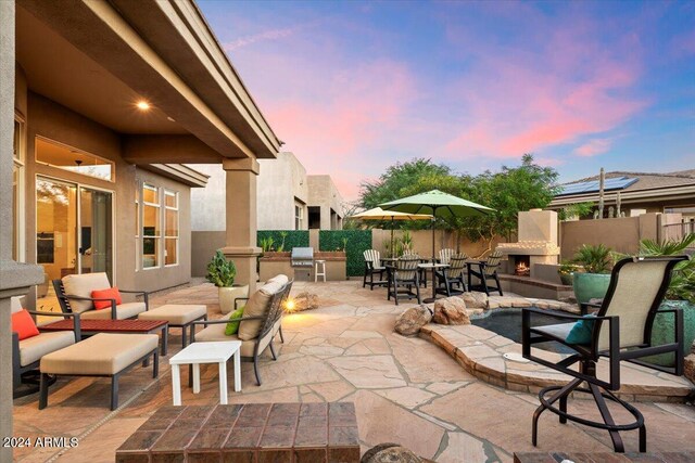 patio terrace at dusk featuring grilling area