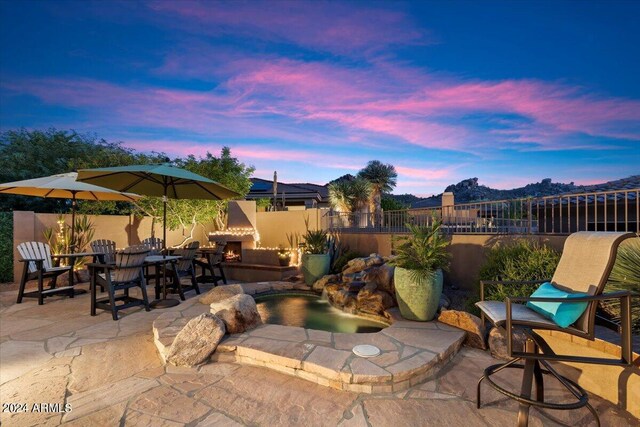 view of patio terrace at dusk