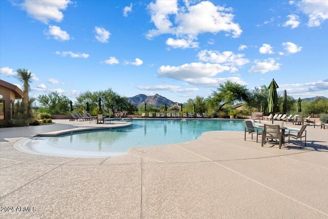 view of pool featuring a patio and a mountain view