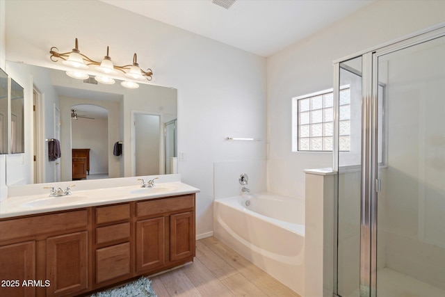 bathroom featuring vanity, ceiling fan, hardwood / wood-style flooring, and separate shower and tub