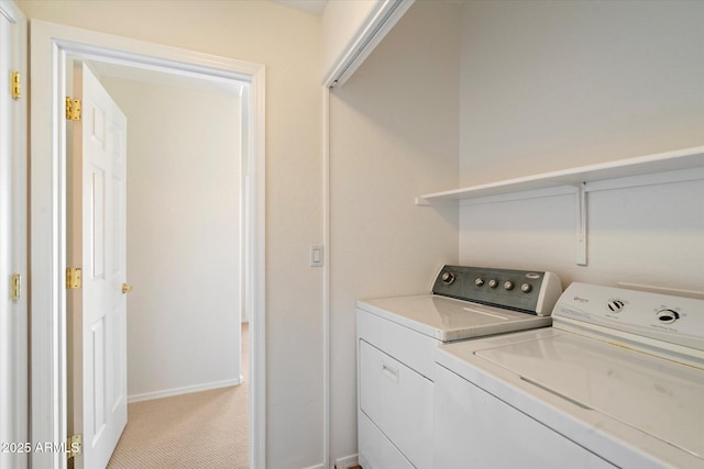 clothes washing area featuring independent washer and dryer and light colored carpet