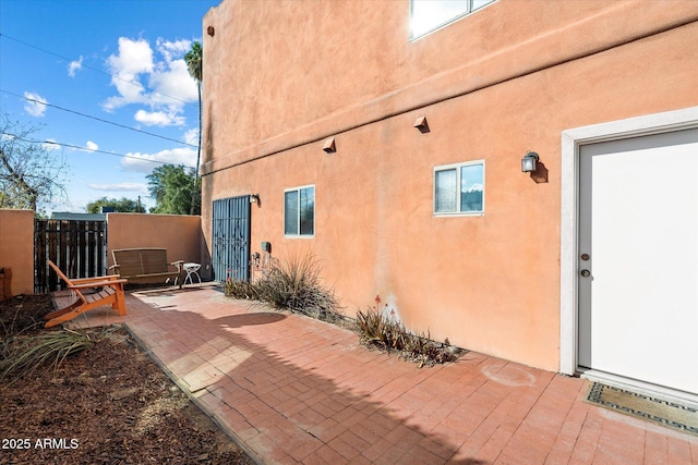 view of property exterior with a patio area