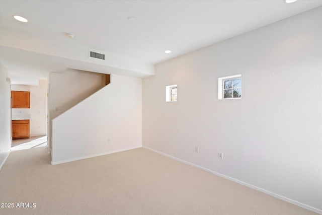 basement featuring light colored carpet