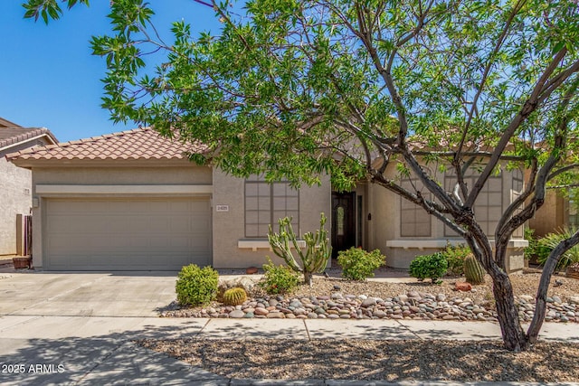 2425 W Red Range Way, Phoenix, AZ 85085 - view of front of house featuring a tiled roof, driveway, stucco siding, and an attached garage