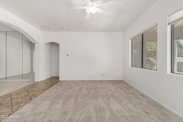 2425 W Red Range Way, Phoenix, AZ 85085 - unfurnished room with arched walkways, a ceiling fan, and carpet floors