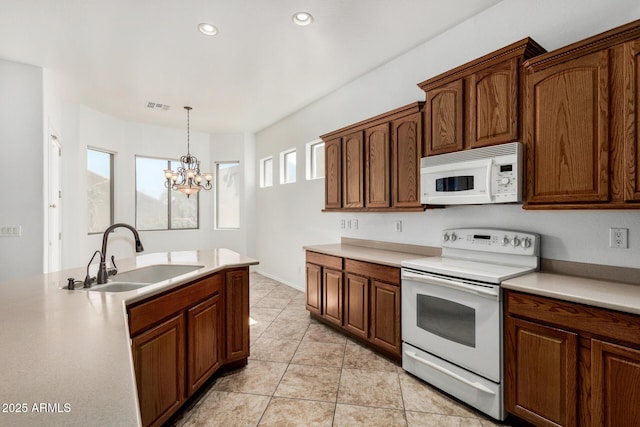 2425 W Red Range Way, Phoenix, AZ 85085 - kitchen with white appliances, a chandelier, pendant lighting, light countertops, and recessed lighting