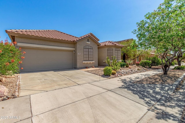 2425 W Red Range Way, Phoenix, AZ 85085 - mediterranean / spanish-style home with driveway, stucco siding, an attached garage, and a tile roof