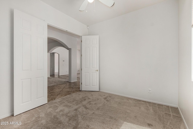 2425 W Red Range Way, Phoenix, AZ 85085 - empty room with carpet flooring, arched walkways, and ceiling fan