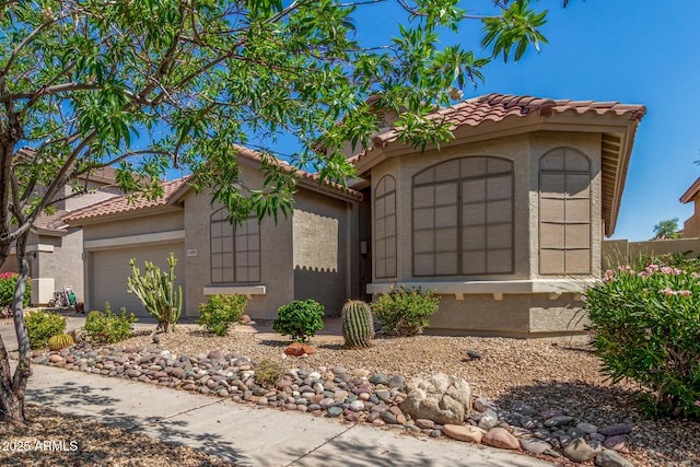 2425 W Red Range Way, Phoenix, AZ 85085 - mediterranean / spanish home featuring a tiled roof, stucco siding, an attached garage, and driveway
