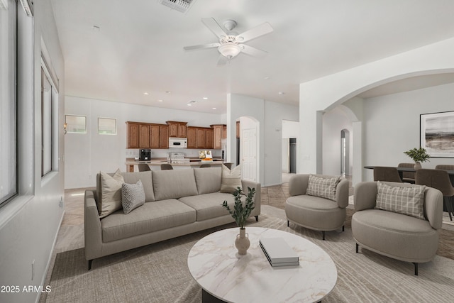 2425 W Red Range Way, Phoenix, AZ 85085 - living area featuring arched walkways, ceiling fan, and recessed lighting
