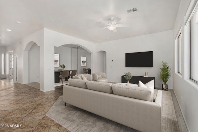 2425 W Red Range Way, Phoenix, AZ 85085 - living room with arched walkways, a ceiling fan, and recessed lighting