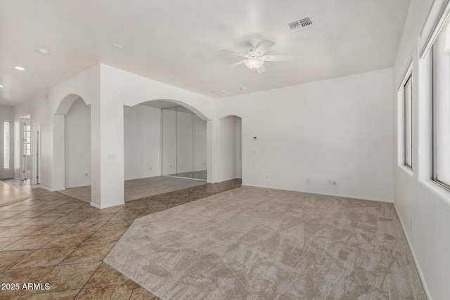 2425 W Red Range Way, Phoenix, AZ 85085 - empty room featuring a ceiling fan and arched walkways