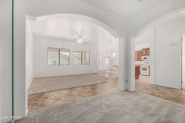 2425 W Red Range Way, Phoenix, AZ 85085 - spare room featuring light colored carpet, light tile patterned flooring, a ceiling fan, and arched walkways