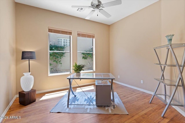 home office with ceiling fan and light hardwood / wood-style flooring