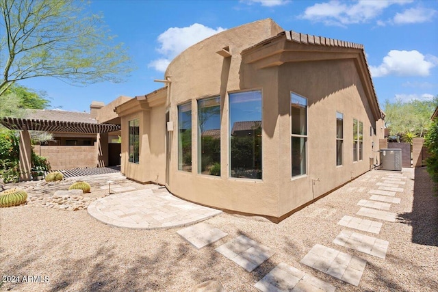 view of property exterior featuring central AC unit and a patio