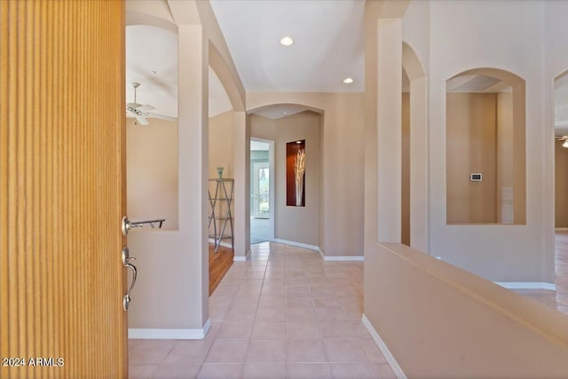 hall featuring light tile patterned flooring