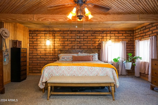 carpeted bedroom with beamed ceiling, brick wall, wooden ceiling, and ceiling fan