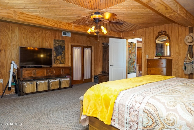 bedroom with ceiling fan, carpet, wooden walls, and wooden ceiling