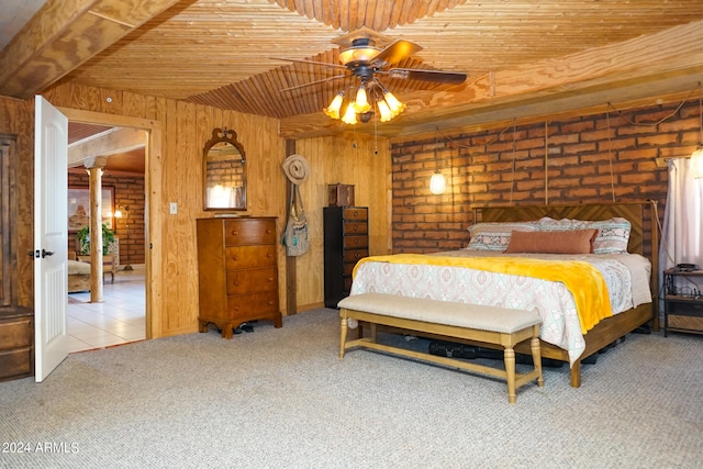 bedroom with ceiling fan, wooden walls, brick wall, light carpet, and wood ceiling