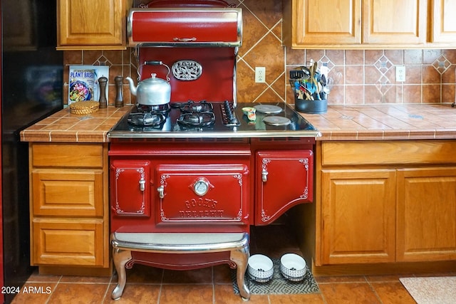 kitchen featuring decorative backsplash, tile counters, and tile patterned floors