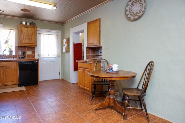 kitchen with black dishwasher, crown molding, backsplash, and tile patterned flooring