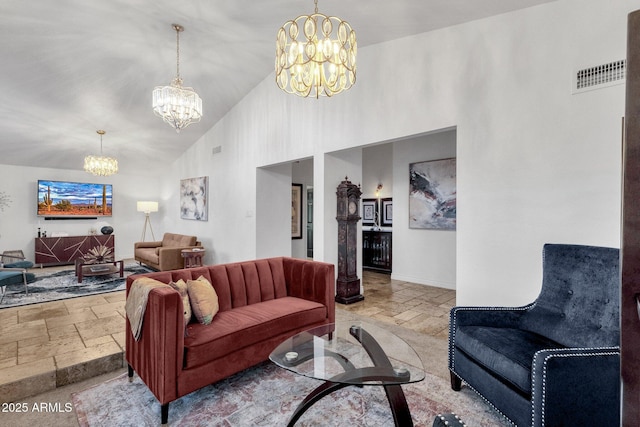 living area featuring high vaulted ceiling, visible vents, a chandelier, and stone tile floors