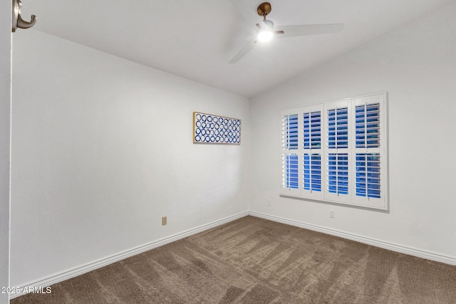 empty room featuring baseboards, vaulted ceiling, ceiling fan, and carpet flooring