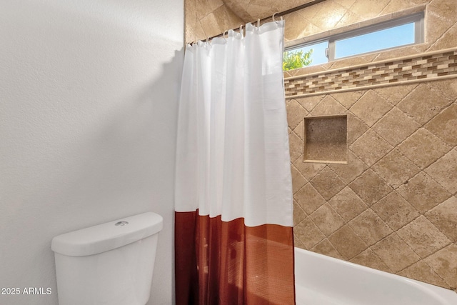 bathroom with shower / bath combination with curtain and toilet