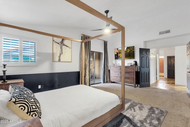 bedroom featuring visible vents, stone tile floors, and light carpet