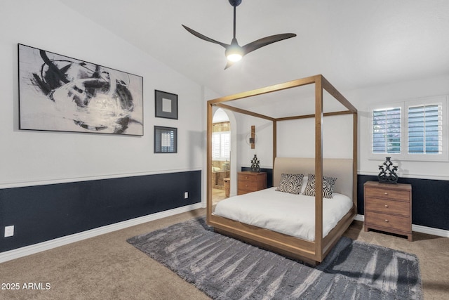 bedroom featuring baseboards, carpet floors, lofted ceiling, and multiple windows