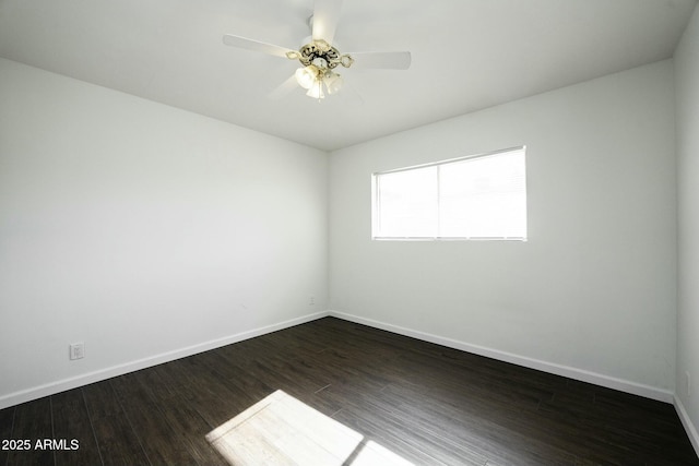 spare room featuring ceiling fan and dark wood-type flooring