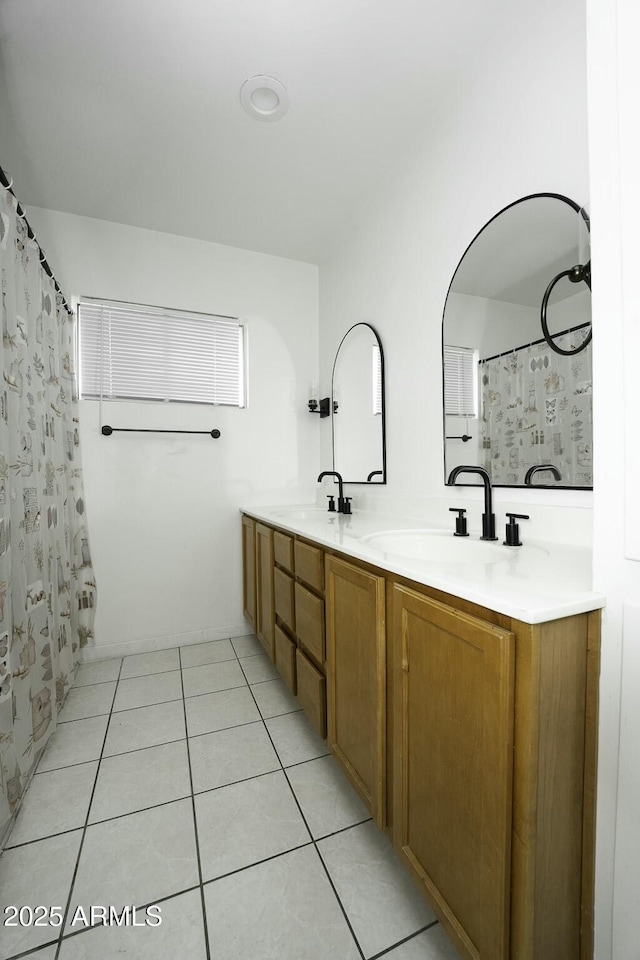 bathroom featuring tile patterned flooring, vanity, and curtained shower