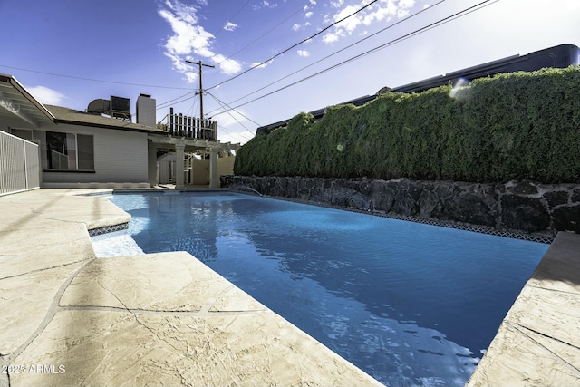 view of pool with a patio area and central air condition unit